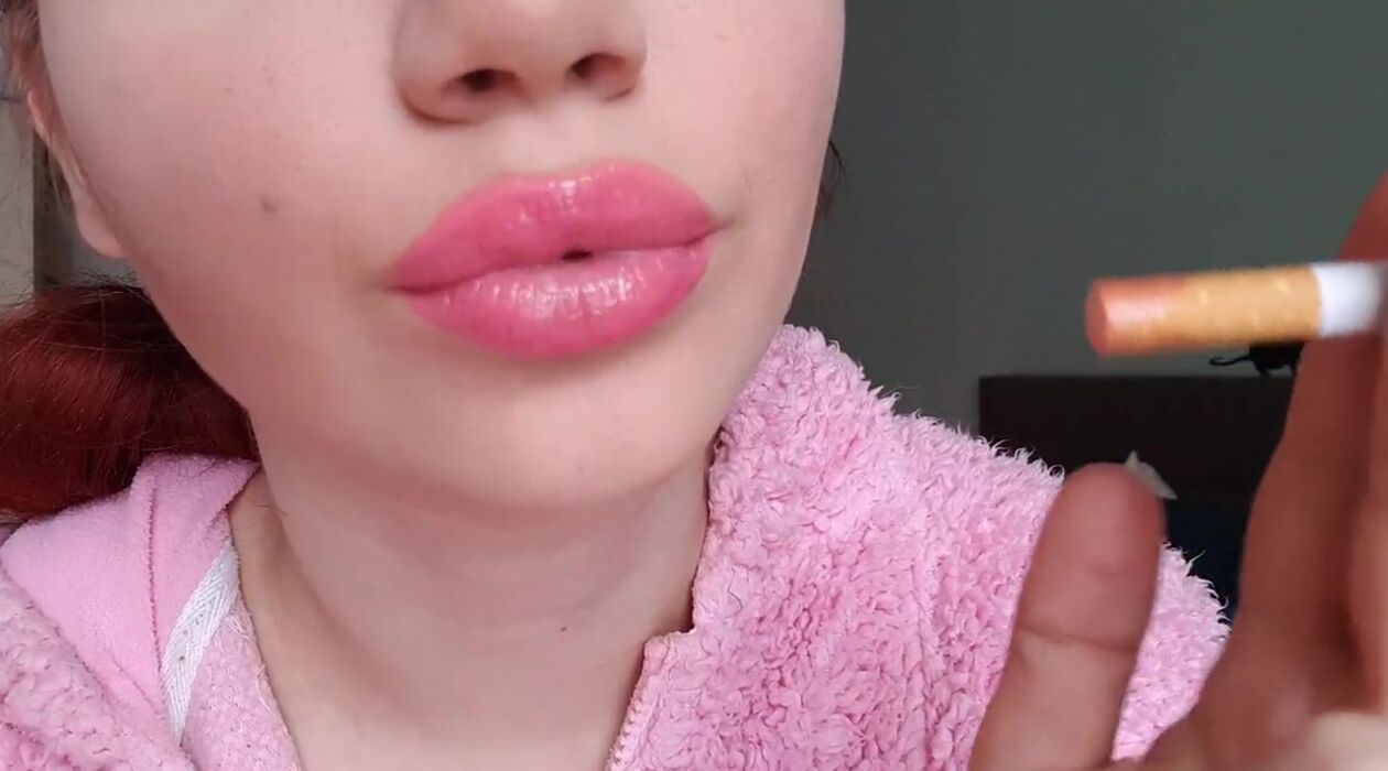 Glossy pink lips close up smoking