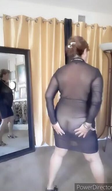 Dancing nude into a transparent dress. Older 67 year woman