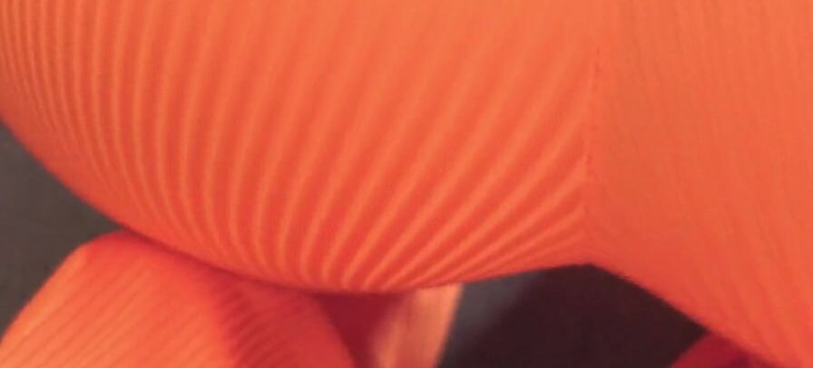 A dark haired into an orange leotard had her booty filled