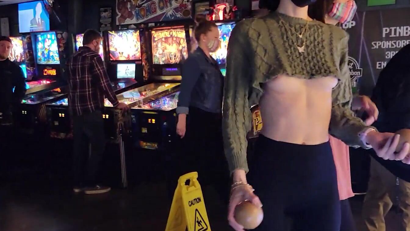 Brazenly flashing melons inside a busy arcade