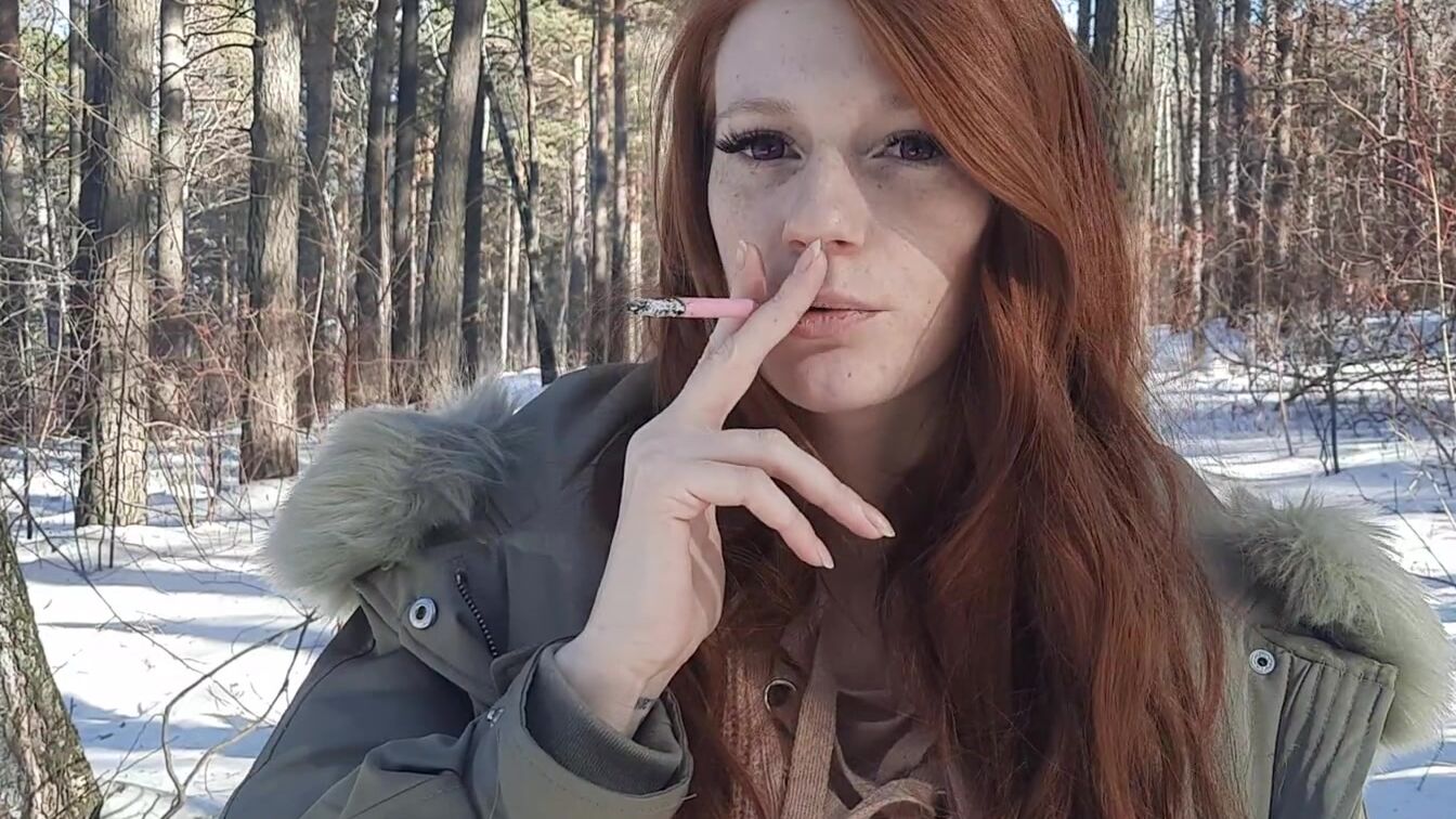 red haired smokes inside the forest