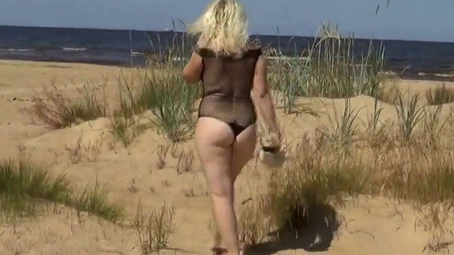 Good woman into a nylon bodysuit on the beach