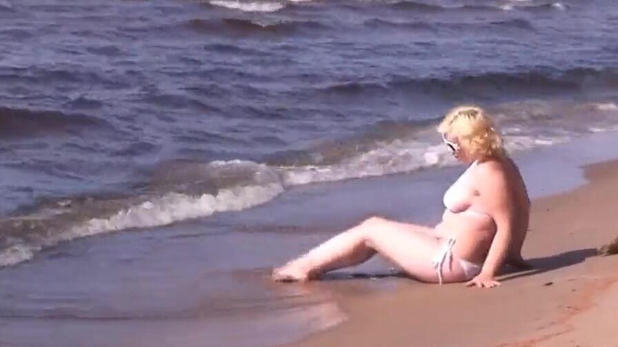 goddess cougar inside a white bikini on the beach